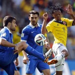 Greece's Sokratis Papastathopoulos, left, challenges Colombia's Juan Cuadrado during the group C World Cup soccer match between Colombia and Greece at the Mineirao Stadium in Belo Horizonte, Brazil, Saturday, June 14, 2014. (AP Photo/Frank Augstein)