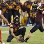 Arizona State's Zane Gonzalez, right, gets ready to kick the game-winning field goal as teammate Mike Bercovici (2) holds the ball as Utah's Davion Orphey (11) looks on in overtime of an NCAA college football game on Saturday, Nov. 1, 2014, in Tempe, Ariz. Arizona State defeated the Utah 19-16 in overtime. (Photo/Ross D. Franklin)