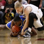 UCLA's Kevon Looney, bottom, battles Arizona State's Jonathan Gilling for the ball during the first half of an NCAA college basketball game, Wednesday, Feb. 18, 2015, in Tempe, Ariz. (AP Photo/Matt York)