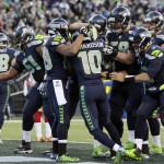 Seattle Seahawks wide receiver Paul Richardson (10) is mobbed by teammates after he scored a touchdown against the San Francisco 49ers in the second half of an NFL football game, Sunday, Dec. 14, 2014, in Seattle. It was Richardson's first NFL touchdown. (AP Photo/John Froschauer)
