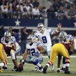 Dallas Cowboys quarterback Tony Romo (9) directs his offense at the line of scrimmage during the first half of an NFL football game against the Washington Redskins, Monday, Oct. 27, 2014, in Arlington, Texas. (AP Photo/Brandon Wade)