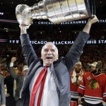 Chicago Blackhawks' head coach Joel Quenneville hoists the Stanley Cup after defeating the Tampa Bay Lightning in Game 6 of the NHL hockey Stanley Cup Final series on Wednesday, June 10, 2015, in Chicago. The Blackhawks defeated the Lightning 2-0 to win the series 4-2. (AP Photo/Nam Y. Huh)
