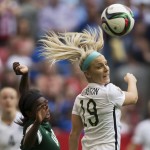 United States' Julie Johnston, right, and Nigeria's Courtney Dike watch the ball during the first half of a FIFA Women's World Cup soccer game Tuesday, June 16, 2105, in Vancouver, British Columbia, Canada. (Darryl Dyck/The Canadian Press via AP)
