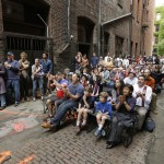 Fans watch a World Cup soccer match between the United States and Germany Thursday, June 26, 2014, from an alley in Seattle's historic Pioneer Square neighborhood. "Nord Alley" has been the site of large-screen viewing parties for World Cup games every match day. (AP Photo/Elaine Thompson)
