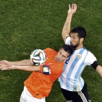 Netherlands' Robin van Persie, left, controls the ball ahead of Argentina's Ezequiel Garay during the World Cup semifinal soccer match between the Netherlands and Argentina at the Itaquerao Stadium in Sao Paulo, Brazil, Wednesday, July 9, 2014. (AP Photo/Francois Xavier Marit, Pool)