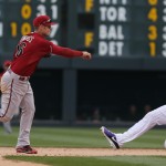  Arizona Diamondbacks shortstop Cliff Owings, left, forces out Colorado Rockies' Nolan Arenado at second base on the front end of a double play hit into by DJ LeMahieu to end the fifth inning of the MLB National League baseball game in Denver on Sunday, April 6, 2014. (AP Photo/David Zalubowski)