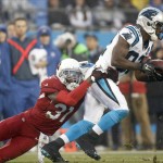 Carolina Panthers' Jerricho Cotchery (82) is tackled by Arizona Cardinals' Antonio Cromartie (31) in the first half of an NFL wild card playoff football game in Charlotte, N.C., Saturday, Jan. 3, 2015. (AP Photo/Bob Leverone)