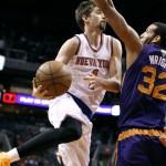 New York Knicks' Alexey Shved, of Russia, left, looks to pass the ball around Phoenix Suns' Brandan Wright (32) during the first half of an NBA basketball game, Sunday, March 15, 2015, in Phoenix. (AP Photo/Ralph Freso)