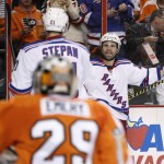 
New York Rangers' Martin St. Louis, right, looks to celebrate his goal with Derek Stepan, middle, as Philadelphia Flyers goalie Ray Emery watches during the first period in Game 3 of an NHL hockey first-round playoff series, Tuesday, April 22, 2014, in Philadelphia. (AP Photo/Chris Szagola)