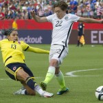 United States' Meghan Klingenberg (22) and Colombia's Angela Clavijo (13) go for the ball during second half FIFA Women's World Cup round of 16 soccer action in Edmonton, Alberta, Canada, Monday, June 22, 2015. (Jason Franson/The Canadian Press via AP)
