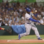 The Dodgers' Yasiel Puig fouls a ball as the Diamondbacks' catcher Miguel Montero reaches out in the first inning of Major League Baseball opening game between the Los Angeles Dodgers and Arizona Diamondbacks at the Sydney Cricket ground in Sydney, Saturday, March 22, 2014. (AP Photo/Rick Rycroft)