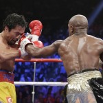 Floyd Mayweather Jr., right, hits Manny Pacquiao, from the Philippines, during their welterweight title fight on Saturday, May 2, 2015 in Las Vegas. (AP Photo/Isaac Brekken)