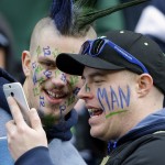 Seattle Seahawks fans take photos on their phone before the NFL football NFC Championship game against the Green Bay Packers Sunday, Jan. 18, 2015, in Seattle. (AP Photo/Elaine Thompson)