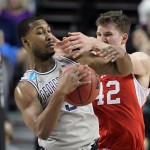 Georgetown forward Mikael Hopkins, left, fights for the ball with Jakob Poeltl during the first half of an NCAA college basketball tournament round of 32 game in Portland, Ore., Saturday, March 21, 2015. (AP Photo/Craig Mitchelldyer)