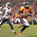 Denver Broncos wide receiver Emmanuel Sanders (10) scores his second touchdown of the NFL football game, as San Diego Chargers cornerback Richard Marshall (31) defends during the first half Thursday, Oct. 23, 2014, in Denver. (AP Photo/Joe Mahoney)
