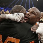 Floyd Mayweather Jr., right, is embraced by his father, head trainer Floyd Mayweather Sr., at the finish of his welterweight title fight against Manny Pacquiao on Saturday, May 2, 2015 in Las Vegas. (AP Photo/Isaac Brekken)