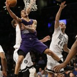 Phoenix Suns' Gerald Green, front left, drives past Brooklyn Nets' Brook Lopez, left, and Bojan Bogdanovic, right, of Croatia, during the first half of an NBA basketball game Friday, March 6, 2015, in New York. (AP Photo/Frank Franklin II)
