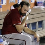 Arizona Diamondbacks starting pitcher Josh Collmenter wipes his face after pitching in the fourth inning during a baseball game against the Arizona Diamondbacks, Sunday, Aug. 17, 2014, in Miami. (AP Photo/Lynne Sladky)