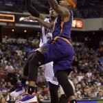 Phoenix Suns guard Isaiah Thomas, right, drives to the basket against Sacramento Kings guard Ben McLemore during the first quarter of an NBA basketball game in Sacramento Calif., Sunday, Feb. 8, 2015.(AP Photo/Rich Pedroncelli)