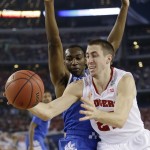 Wisconsin guard Josh Gasser, right, drives to the basket past Kentucky guard Dominique Hawkins during the first half of an NCAA Final Four tournament college basketball semifinal game Saturday, April 5, 2014, in Arlington, Texas. (AP Photo/David J. Phillip)