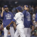 Los Angeles Dodgers' Howie Kendrick, center, and his teammates including Scott Van Slyke, second from left, and starting pitcher Clayton Kershaw, right, celebrate the team's 3-1 win over the Arizona Diamondbacks in a baseball game, Tuesday, June 9, 2015, in Los Angeles. (AP Photo/Jae C. Hong)