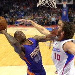 Phoenix Suns guard Eric Bledsoe, left, puts up a shot as Los Angeles Clippers forward Spencer Hawes defends during the first half of a preseason NBA basketball game, Wednesday, Oct. 22, 2014, in Los Angeles. (AP Photo/Mark J. Terrill)