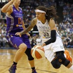 Minnesota Lynx guard Seimone Augustus (33) drives the ball around Phoenix Mercury forward Penny Taylor (13) during the second half of Game 2 of the WNBA basketball Western Conference finals, Sunday, Aug. 31, 2014, in Minneapolis. The Lynx won 82-77. (AP Photo/Stacy Bengs)
