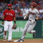 Texas Rangers second baseman Rougned Odor and Arizona Diamondbacks' Paul Goldschmidt look to the outfield as Goldschmidt advances on a single by Yasmany Tomas during the first inning of an interleague baseball game Tuesday, July 7, 2015, in Arlington, Texas. (AP Photo/Tony Gutierrez)