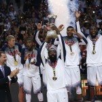United States players celebrate their victory, raising the trophy next to King Felipe VI of Spain, left, after winning the final World Basketball match against Serbia at the Palacio de los Deportes stadium in Madrid, Spain, Sunday, Sept. 14, 2014. (AP Photo/Daniel Ochoa de Olza)