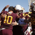 Arizona State's Taylor Kelly (10) is congratulated by teammates during Senior Day introductions prior to an NCAA college football game against Washington State, Saturday, Nov. 22, 2014, in Tempe, Ariz. (AP Photo/Ross D. Franklin)
