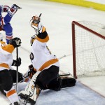 New York Rangers' Derek Stepan (21) shoots the puck past Philadelphia Flyers goalie Ray Emery (29) during the third period in Game 1 of an NHL hockey first-round playoff series on Thursday, April 17, 2014, in New York. The Rangers won the game 4-1. (AP Photo/Frank Franklin II)
