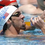 Michael Phelps stops for a drink during training Wednesday, April 23, 2014, in Mesa, Ariz. Phelps is competing in the Arena Grand Prix in Mesa on Thursday in an attempt to return to swimming. (AP Photo/Matt York)