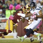 Washington Redskins strong safety Brandon Meriweather (31) reaches for Seattle Seahawks wide receiver Jermaine Kearse (15) after Kearse pulls in a touchdown pass during the first half of an NFL football game in Landover, Md., Monday, Oct. 6, 2014. (AP Photo/Nick Wass)
