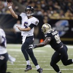 Baltimore Ravens quarterback Joe Flacco (5) passes under pressure from New Orleans Saints outside linebacker Parys Haralson (98) in the second half of an NFL football game in New Orleans, Monday, Nov. 24, 2014. (AP Photo/Rogelio Solis)