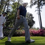 Jordan Spieth walks with his caddie Michael Greller to the sixth green during the third round of the Masters golf tournament Saturday, April 12, 2014, in Augusta, Ga. (AP Photo/Darron Cummings)