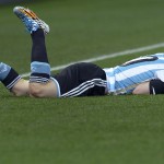 Argentina's Lionel Messi lays on the pitch after being fouled during the World Cup semifinal soccer match between the Netherlands and Argentina at the Itaquerao Stadium in Sao Paulo Brazil, Wednesday, July 9, 2014. (AP Photo/Manu Fernandez)