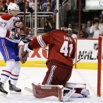 Arizona Coyotes' Mike Smith (41) makes a save in front of Montreal Canadiens' Alex Galchenyuk (27) during the first period of an NHL hockey game Saturday, March 7, 2015, in Glendale, Ariz. (AP Photo/Ross D. Franklin)
