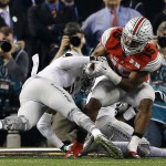 Ohio State's Ezekiel Elliott runs for a nine-yard touchdown during the second half of the NCAA college football playoff championship game against Oregon Monday, Jan. 12, 2015, in Arlington, Texas. (AP Photo/Brandon Wade)