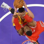 Los Angeles Lakers guard Jeremy Lin, top, goes up for a shot as Houston Rockets center Dwight Howard defends during the first half of an NBA basketball game, Tuesday, Oct. 28, 2014, in Los Angeles. (AP Photo/Mark J. Terrill)
