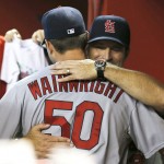 St. Louis Cardinals manager Mike Matheny, right, celebrates with Adam Wainwright (50) after clinching the National League Central Division in the first inning during a baseball game against the Arizona Diamondbacks, Sunday, Sept. 28, 2014, in Phoenix. (AP Photo/Rick Scuteri)