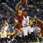 Southern California's Julian Jacobs shoots against Arizona State's Savon Goodman (11) in the first half of an NCAA college basketball game in the first round of the Pac-12 Conference tournament Wednesday, March 11, 2015, in Las Vegas. (AP Photo/John Locher)
