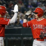 Los Angeles Angels' Johnny Giavotella, right, celebrates his home run against the Arizona Diamondbacks with Kole Calhoun, left, during the third inning of a baseball game Thursday, June 18, 2015, in Phoenix. (AP Photo/Ross D. Franklin)