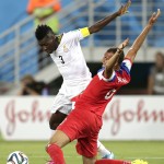 Ghana's Asamoah Gyan, left, tries to get past United States' John Brooks during the group G World Cup soccer match between Ghana and the United States at the Arena das Dunas in Natal, Brazil, Monday, June 16, 2014. (AP Photo/Dolores Ochoa)
