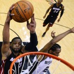 Miami Heat guard Dwyane Wade (3) attempts a dunk as San Antonio Spurs forward Kawhi Leonard defends during the first half in Game 2 of the NBA basketball finals on Saturday, Nov. 8, 2014, in San Antonio. (AP Photo/Larry W. Smith, pool)
