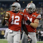 Ohio State's Cardale Jones (12) is congratulated by Nick Vannett (81) after running for a touchdown during the first half of the NCAA college football playoff championship game against Oregon Monday, Jan. 12, 2015, in Arlington, Texas. (AP Photo/LM Otero)