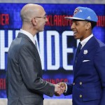 Cameron Payne, right, is greeted by NBA Commissioner Adam Silver after being selected 14th overall by the Oklahoma City Thunder during the NBA basketball draft, Thursday, June 25, 2015, in New York. (AP Photo/Kathy Willens)
