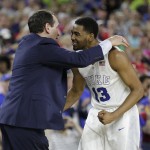 Duke head coach Mike Krzyzewski celebrates with Matt Jones after the second half of a college basketball regional final game against Gonzaga in the NCAA Tournament Sunday, March 29, 2015, in Houston. Duke won 66-52. (AP Photo/Charlie Riedel)