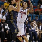 Arizona's Gabe York, right, guards California's Sam Singer in the second half of an NCAA college basketball game in the quarterfinals of the Pac-12 conference tournament Thursday, March 12, 2015, in Las Vegas. Arizona won 73-51. (AP Photo/John Locher)