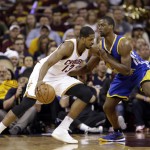 Cleveland Cavaliers center Tristan Thompson (13) goes to the basket against Golden State Warriors forward Harrison Barnes (40) during the first half of Game 6 of basketball's NBA Finals in Cleveland, Tuesday, June 16, 2015. (AP Photo/Tony Dejak)
