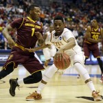  Texas guard Isaiah Taylor (1) drives against Arizona State guard Jahii Carson (1) during the first half of a second-round game in the NCAA college basketball tournament Thursday, March 20, 2014, in Milwaukee. (AP Photo/Jeffrey Phelps)